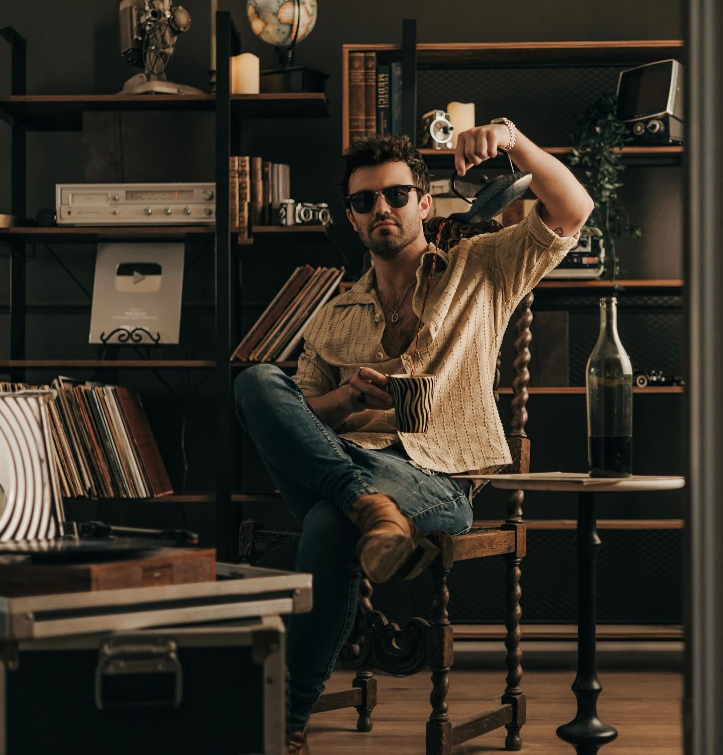 Blake McLain in the studio with record shelves