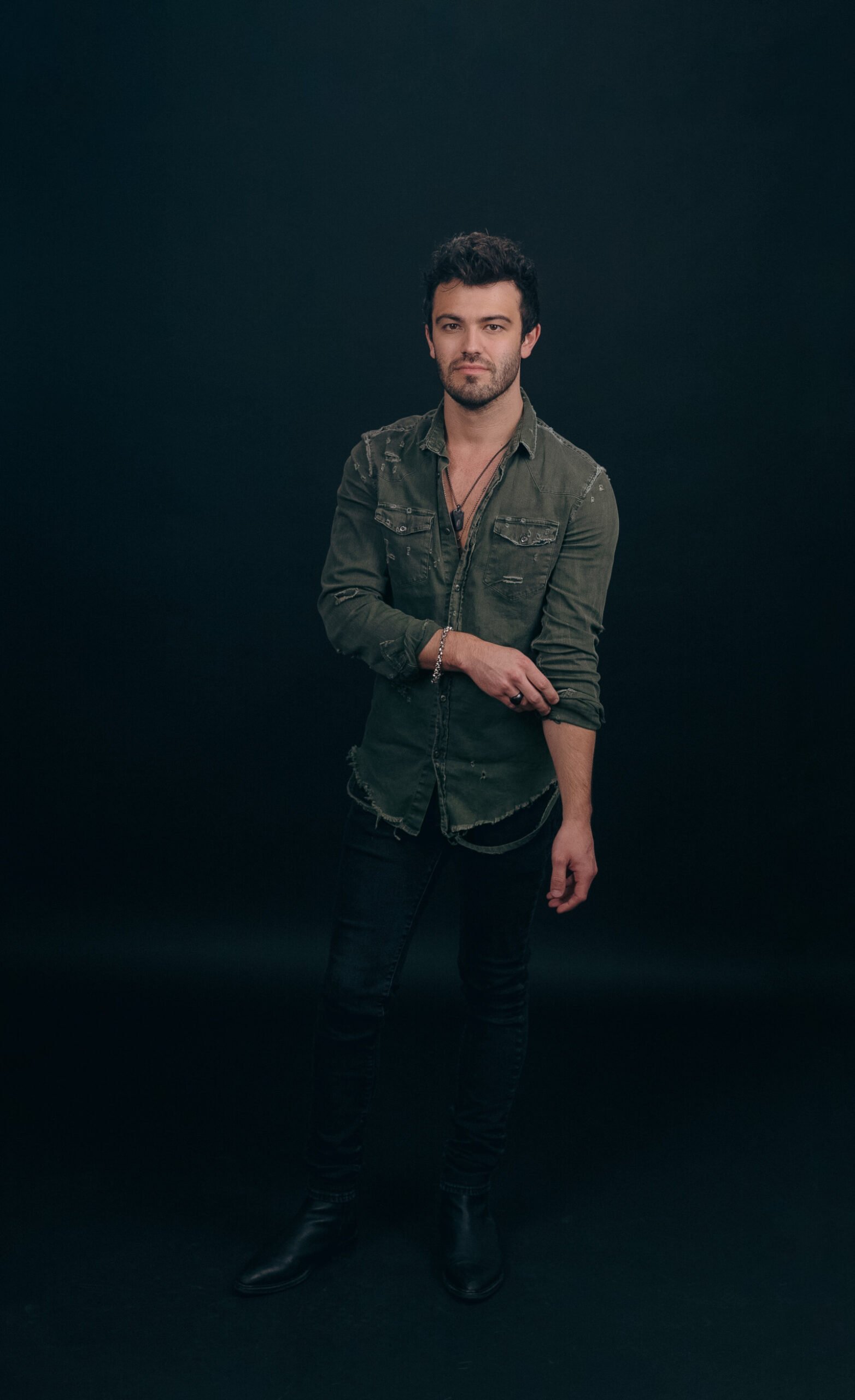 Blake McLain full-length editorial portrait on dark backdrop