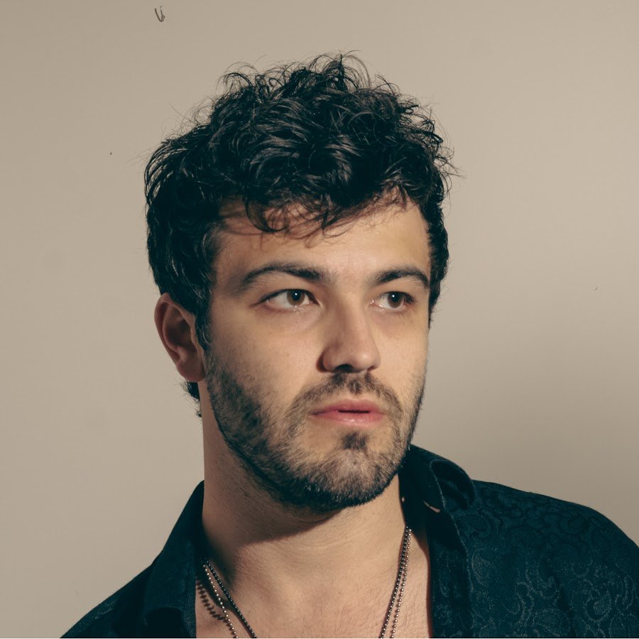 Blake McLain studio portrait, warm backdrop